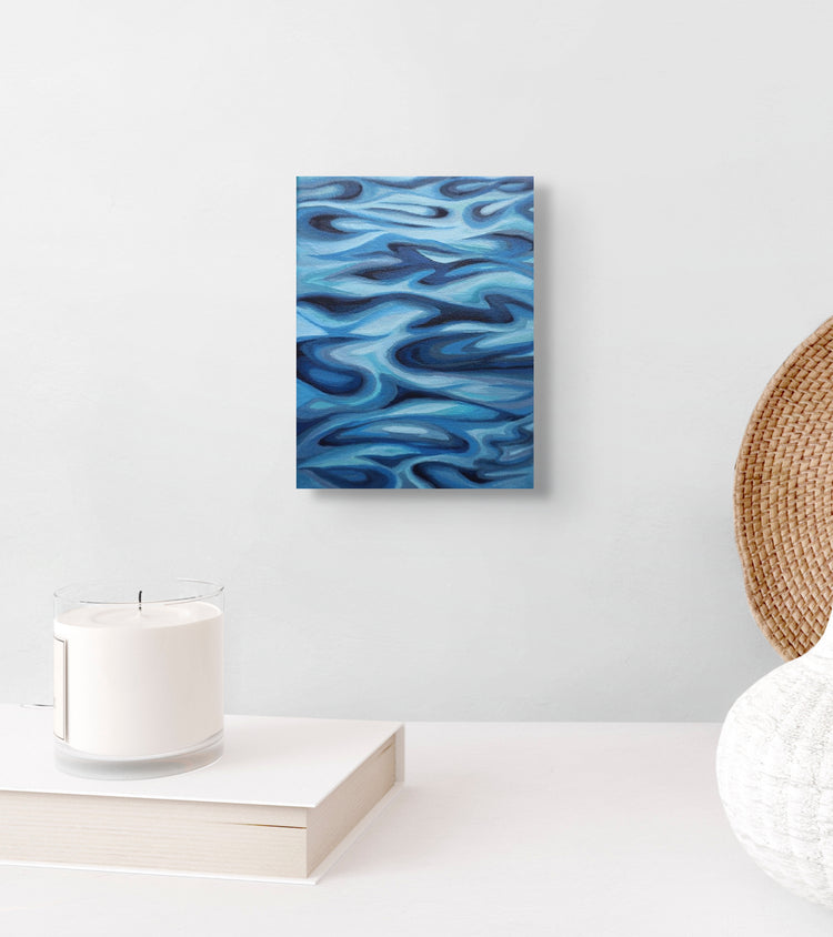 Shifting Blue original painting displayed in home, coastal artwork by Ellie Antonacci